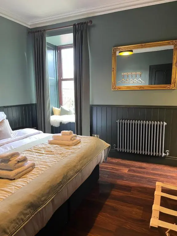 a bedroom with a bed with towels on it at Lewis Lodge - Stunning & Exclusive Luxury Home in the Heart of Ballater, Royal Deeside in Ballater