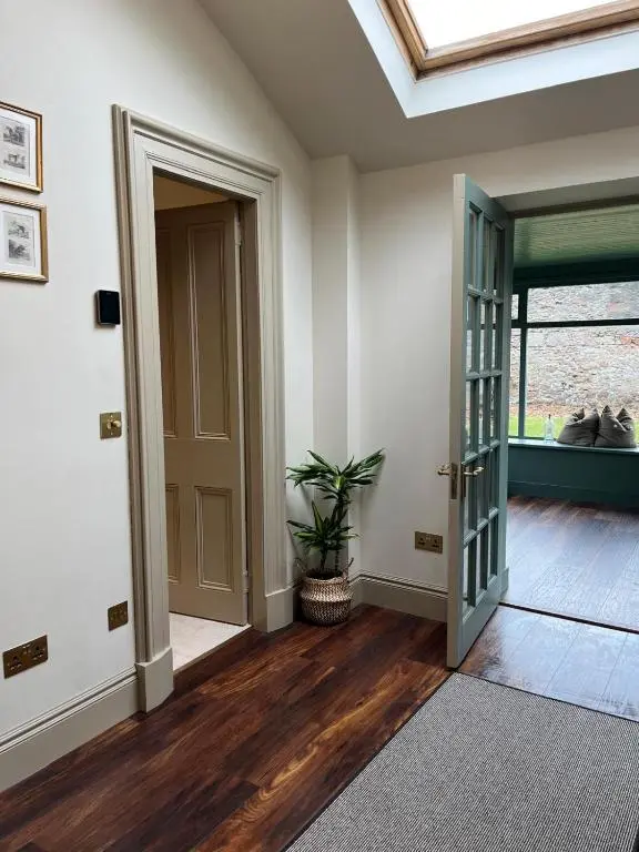 an empty room with a door and a potted plant at Lewis Lodge - Stunning & Exclusive Luxury Home in the Heart of Ballater, Royal Deeside in Ballater