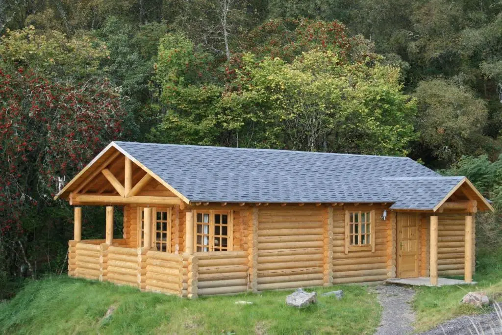 a log cabin with a black roof at BCC Loch Ness Log Cabins in Bearnock