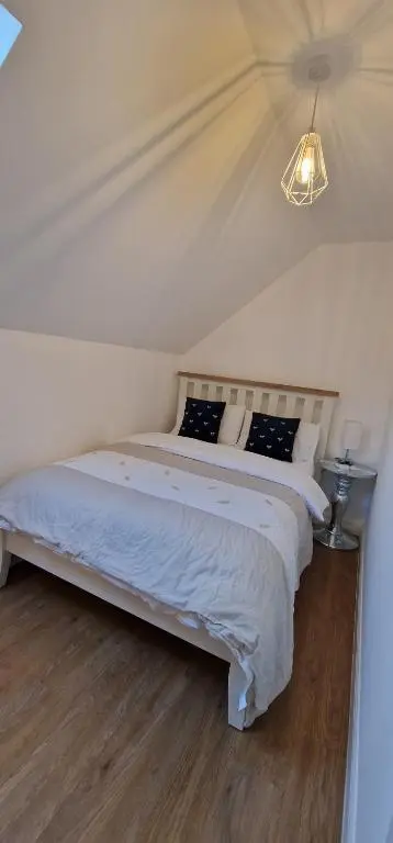 a bedroom with a large bed in a room at The Flat at Clocktower Buildings in Kinloss