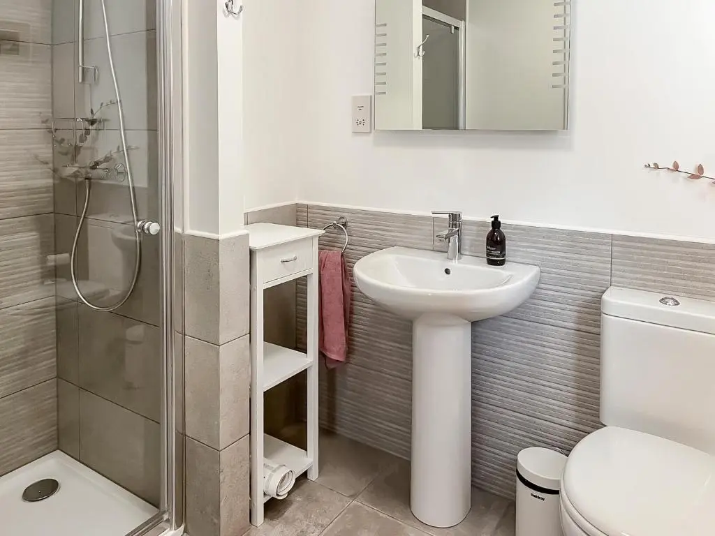 a bathroom with a sink and a toilet and a shower at No 8 Cottage in Aviemore