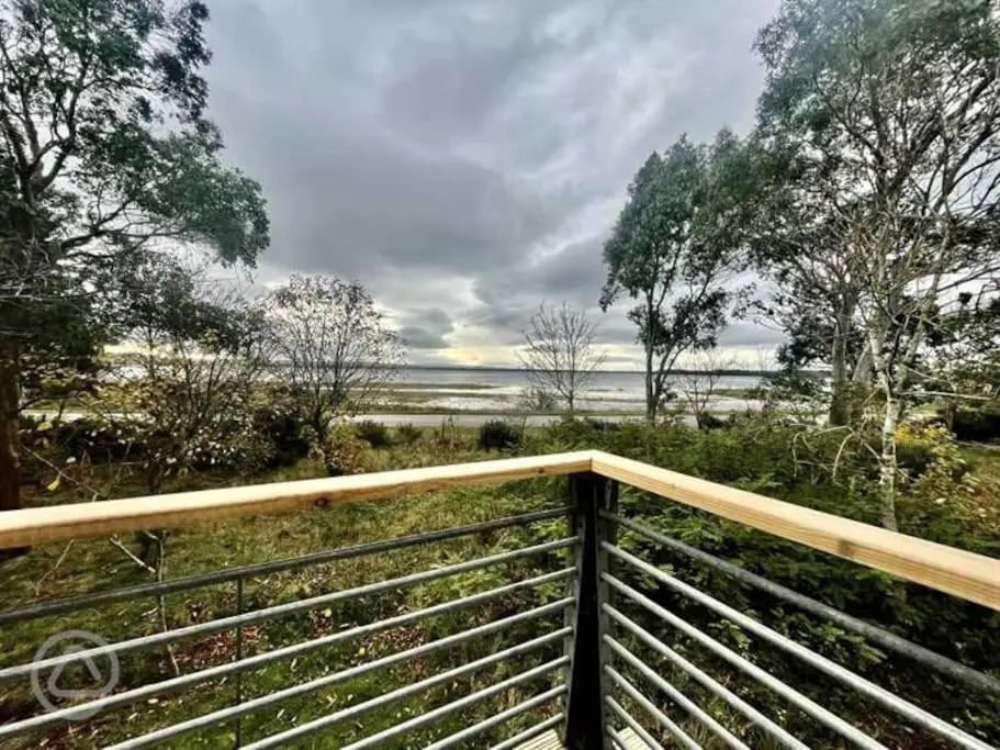 a balcony with a view of the water at Findhorn Bay - Sandpiper Eco chalet in Findhorn
