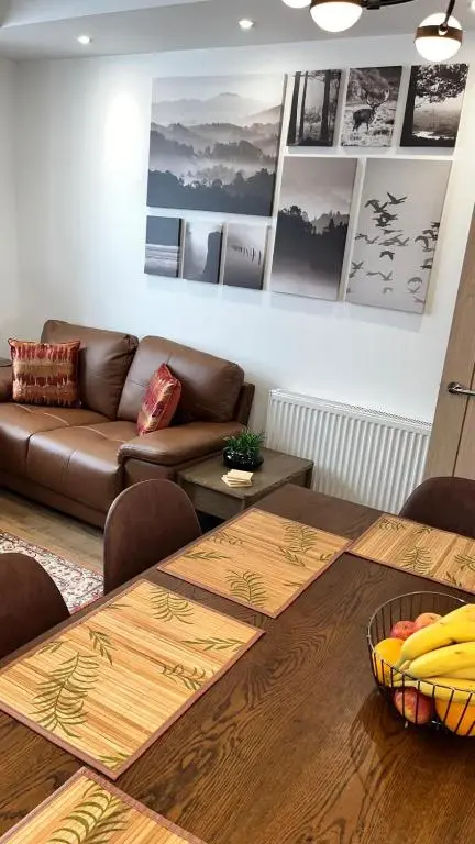 a living room with a couch and a table at 23 Innes Street Apartment in Inverness