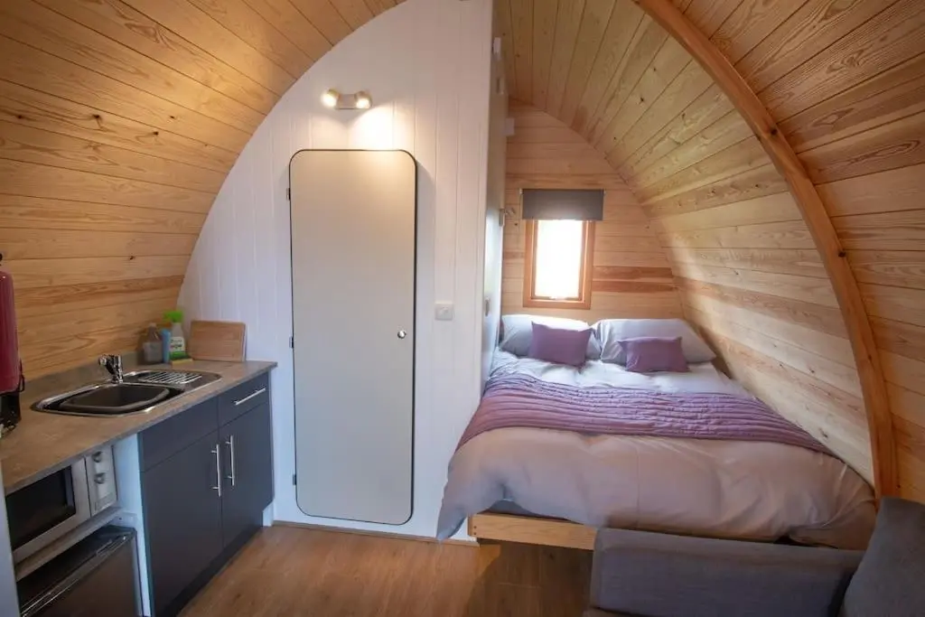 a bedroom with a bed in a wooden room at Findhorn Ecovillage Escape Eco Pod Pet free in Findhorn