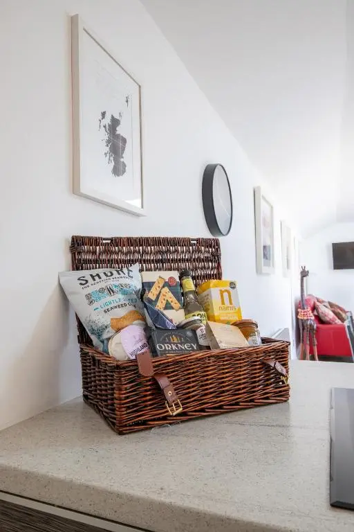 a basket sitting on a counter with a table at Cairnie Cottage in Ballater