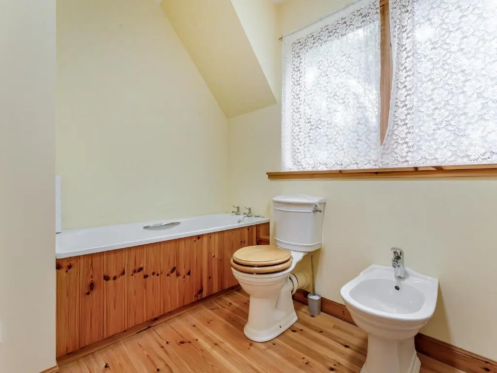 a bathroom with a toilet and a sink at Bridge House in Evanton