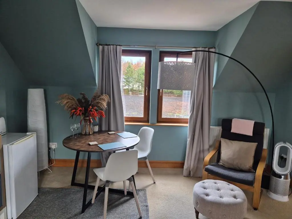 a room with a table and chairs and a window at Twin Pines in Mulben