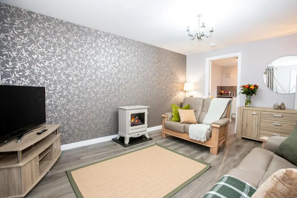 a living room with a tv and a fireplace at Inverness Apartment - Uist in Inverness