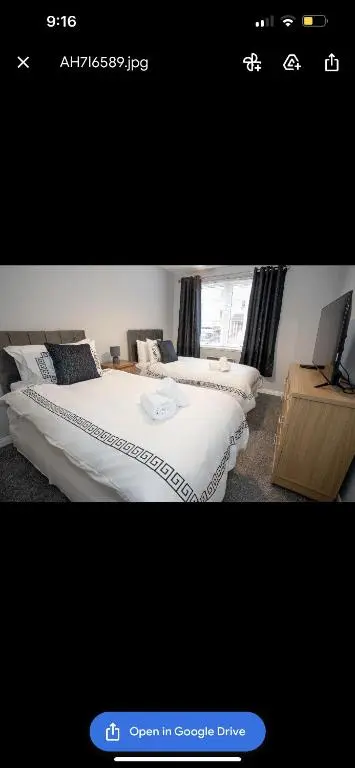 a picture of a bedroom with two beds and a tv at Inverness Apartment - Uist in Inverness