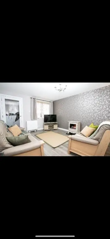 a living room with two couches and a table at Inverness Apartment - Uist in Inverness
