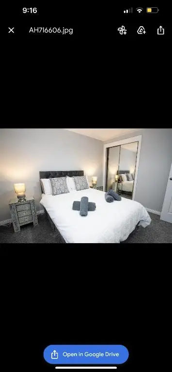 a bedroom with a white bed and a mirror at Inverness Apartment - Uist in Inverness