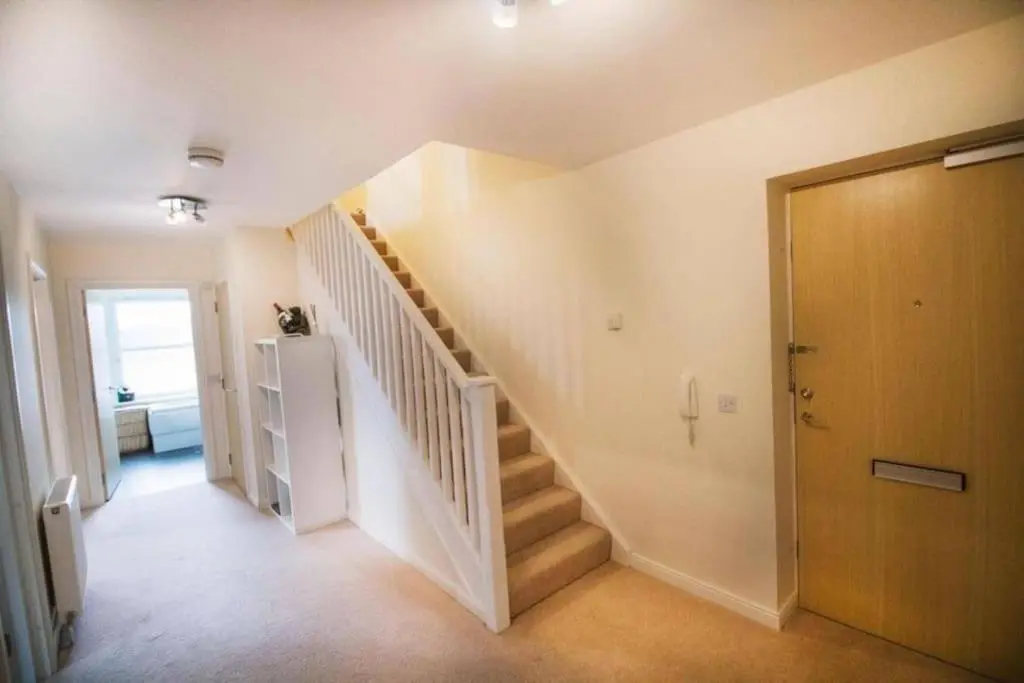 a hallway with a staircase in a house at Inverurie Town Centre 97m2 Maisonette in Inverurie