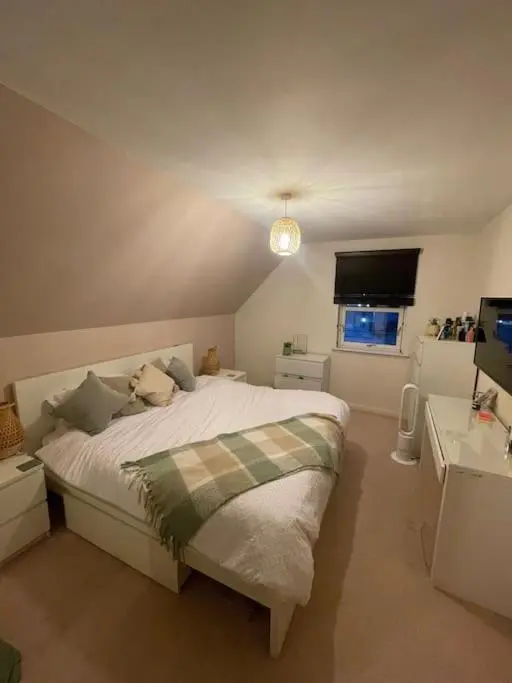 a bedroom with a bed with a teddy bear on it at Inverurie Town Centre 97m2 Maisonette in Inverurie