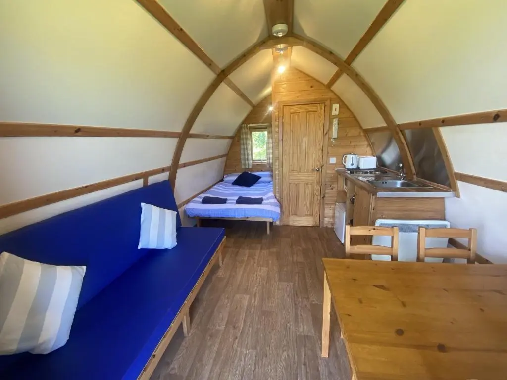 a room with a blue bench in a dome house at Greenley Croft Glamping by Wigwam in Crovie