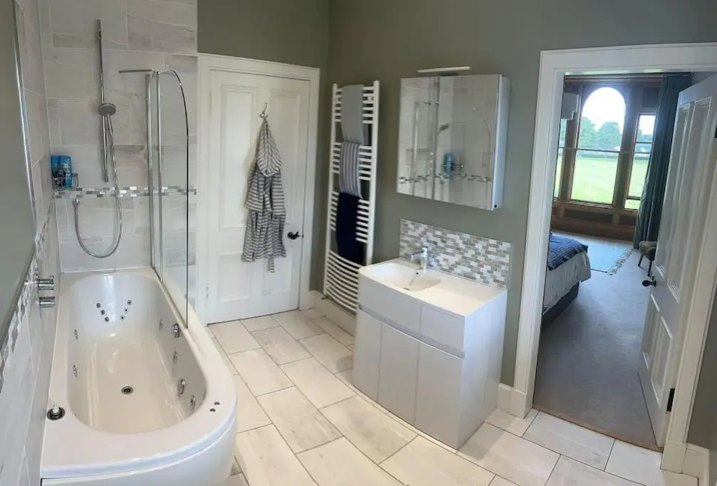 a bathroom with a tub and a sink and a shower at Victorian Home in Moray in Forres