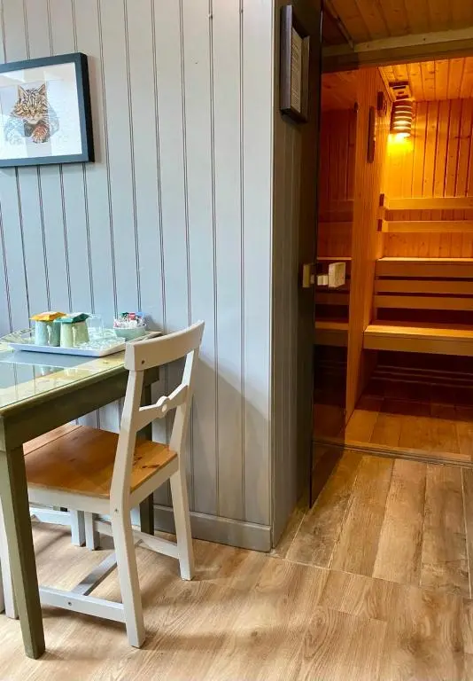 a table and a chair in a room with a stairs at Highland Rooms - Room Only No Breakfast in Ullapool