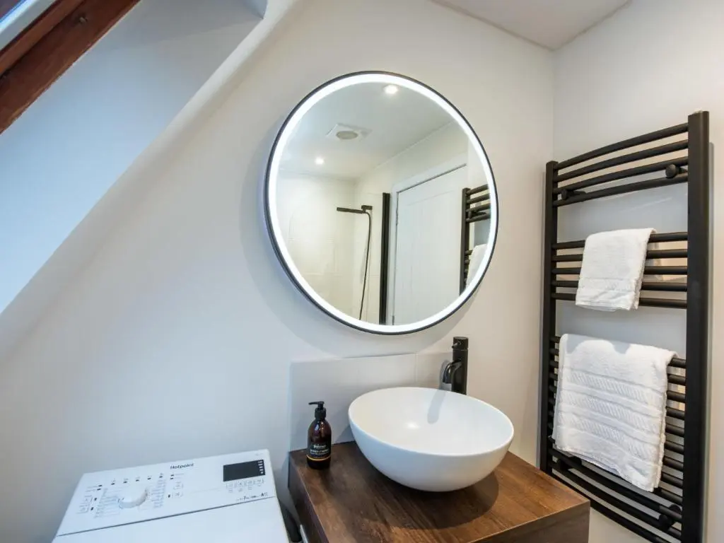a bathroom with a white sink and a mirror at Chalet Lodge 6 by Interhome in Spean Bridge