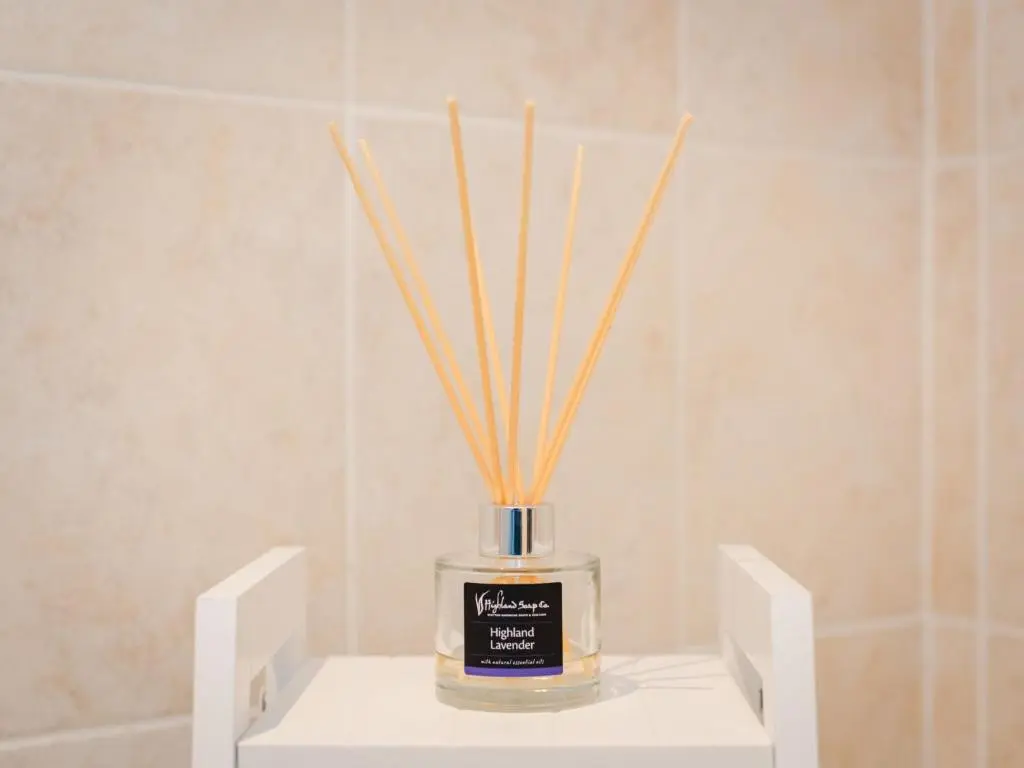 a vase with sticks in it sitting on a shelf at Chalet Lodge 6 by Interhome in Spean Bridge