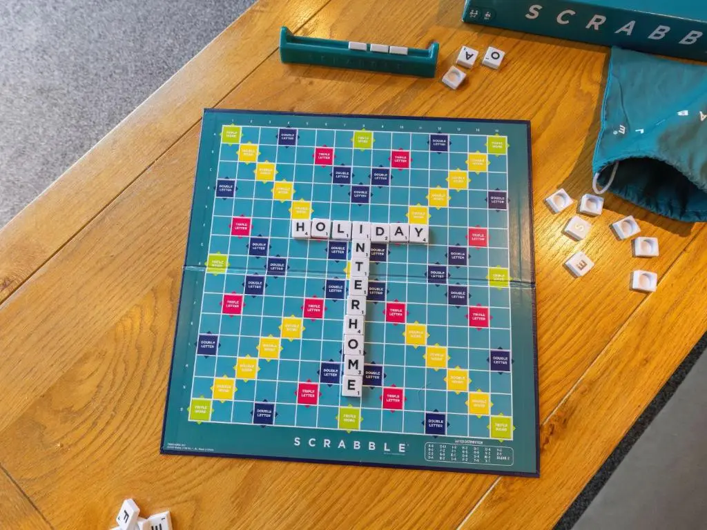 a monopoly board on a wooden table with a game at Chalet Lodge 6 by Interhome in Spean Bridge