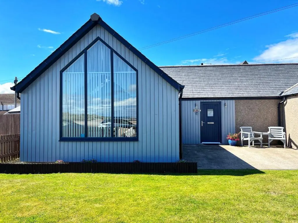 a house with a large window on the side of it at The Annexe in Lossiemouth