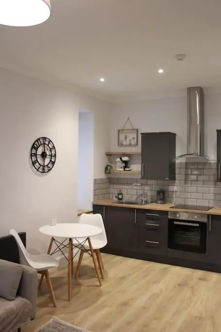 a kitchen with a table and a table and chairs at One bedroom Flat in Dingwall in Dingwall