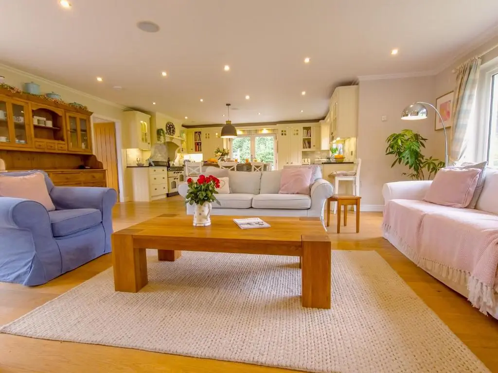 a living room with a couch and a coffee table at The Bellhouse - hot tub lodge in Tomatin in Tomatin