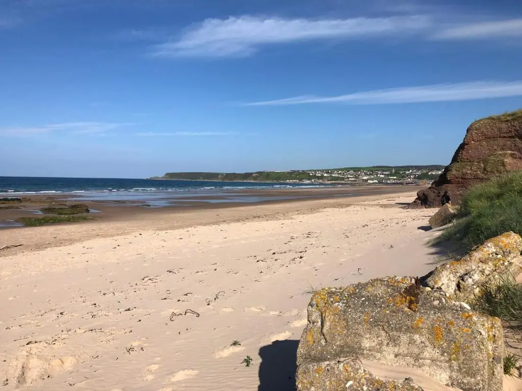 a beach with a large rock and the ocean at The Three Kings Inn in Cullen