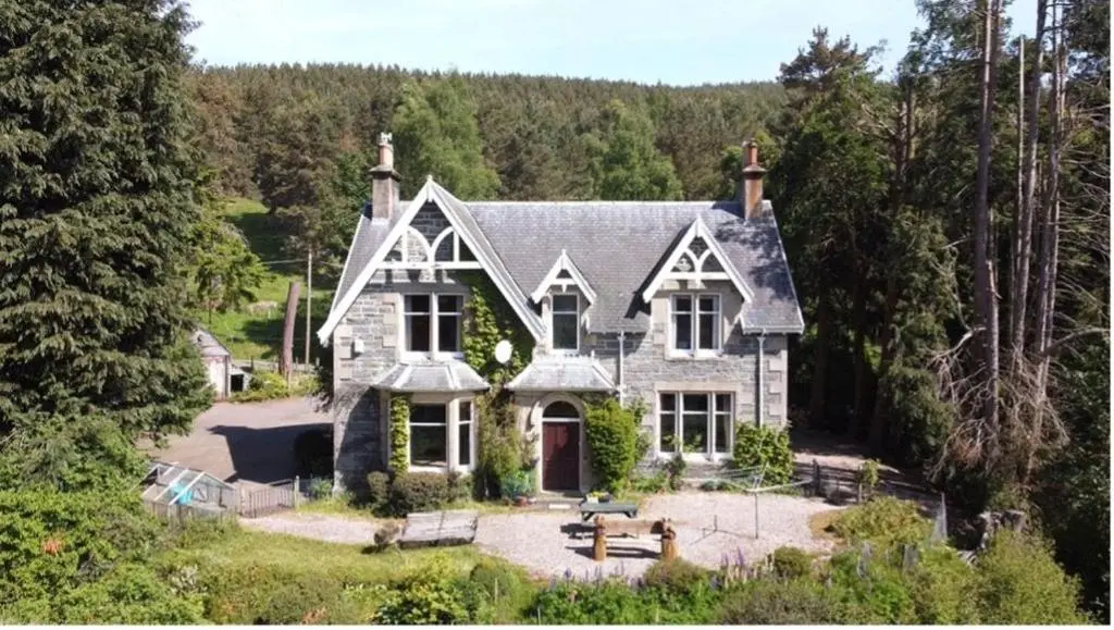 a house in the middle of a forest at Ardchoile in Kingussie