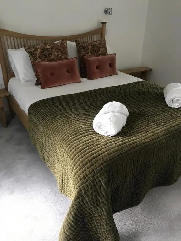 a bed with two white pillows on top of it at St Vincents in Kingussie