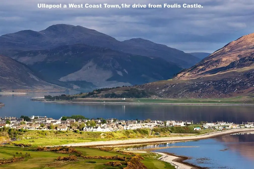 a town next to a body of water with mountains at Foulis Cottage, Foulis Estate, Highland Scotland in Ardullie