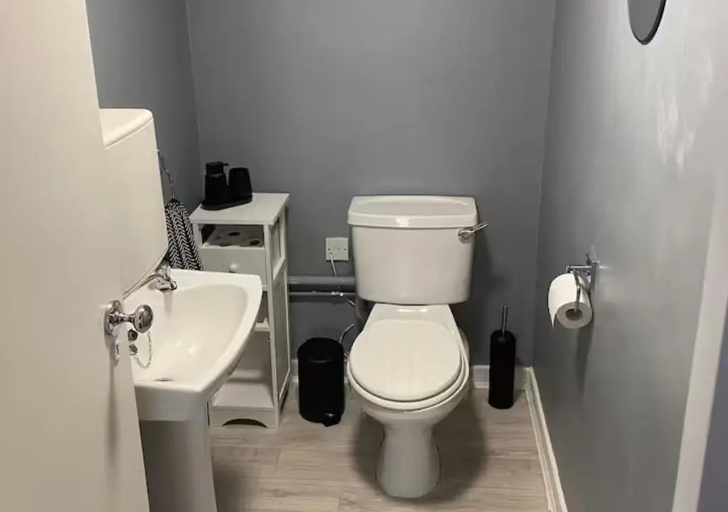 a bathroom with a white toilet and a sink at Frithside Retreat 3BR Sleeps 7 Coastal Getaway in Fraserburgh