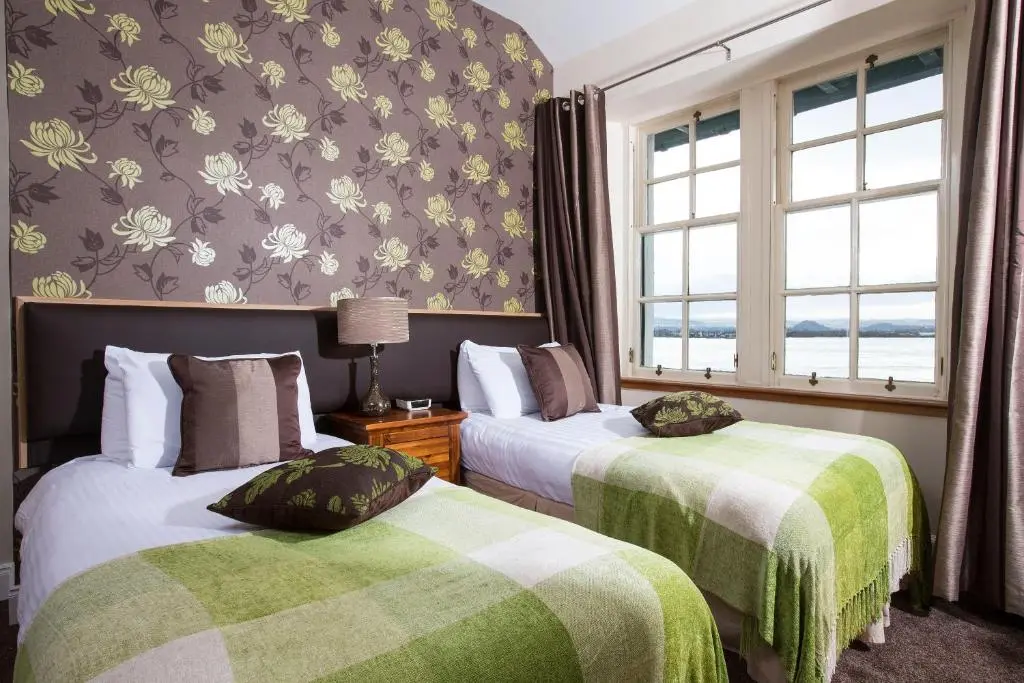 a hotel room with two beds and a window at North Kessock Hotel in Inverness