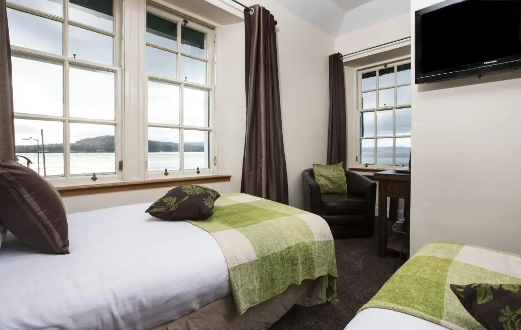 a hotel room with two beds and a window at North Kessock Hotel in Inverness