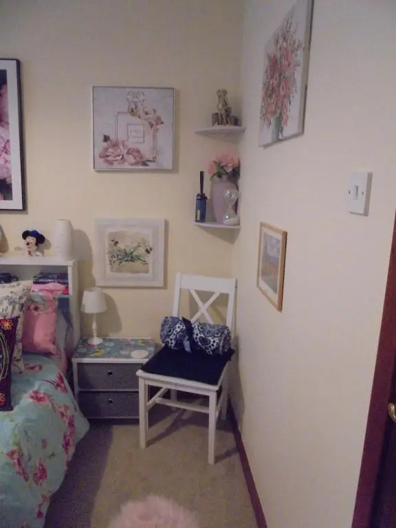 a bedroom with a bed and a chair and a dresser at 3 Station Court, Munlochy in Munlochy