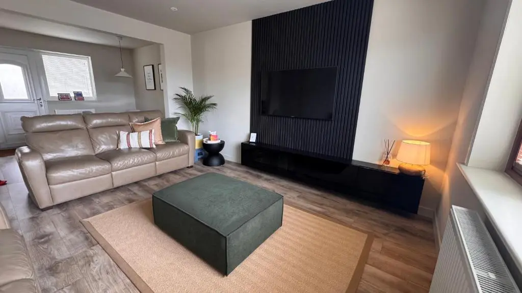 a living room with a couch and a television at No 67 West Road in Fraserburgh