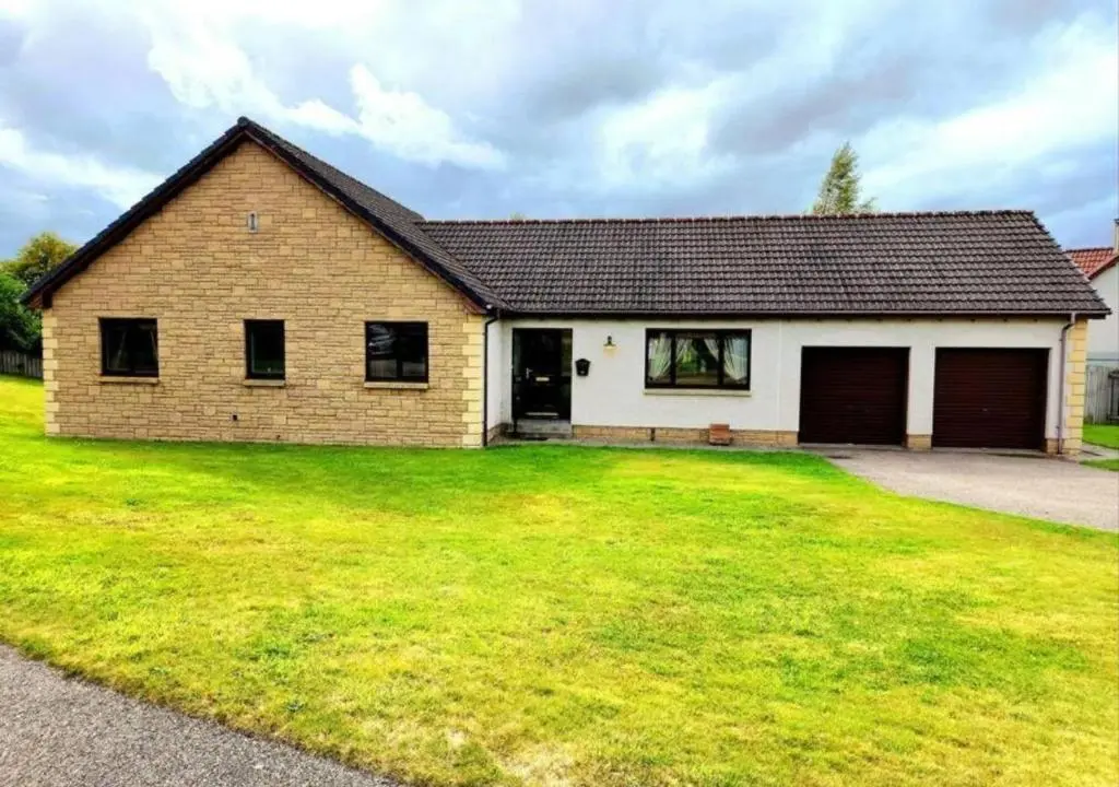 a brick house with a large grass yard at Boutique Four Bed Holiday Home in Inverness in Inverness