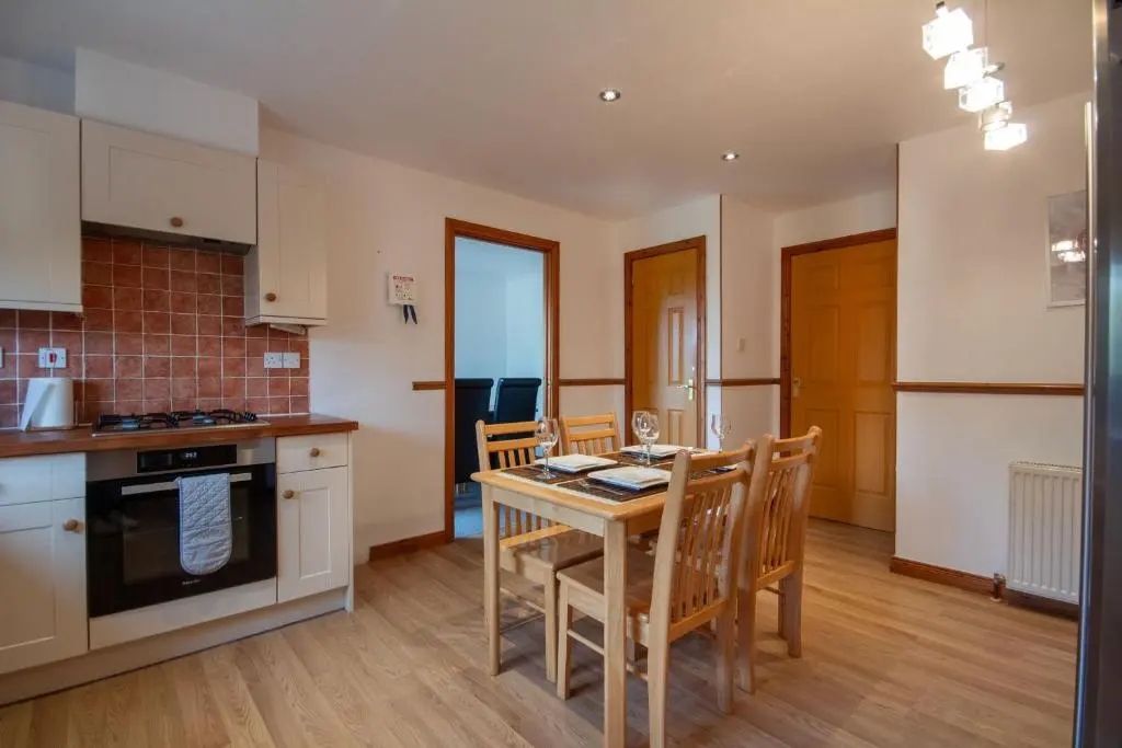 a kitchen and dining room with a table and chairs at Boutique Four Bed Holiday Home in Inverness in Inverness