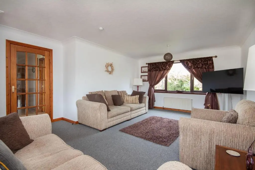 a living room with two couches and a tv at Boutique Four Bed Holiday Home in Inverness in Inverness