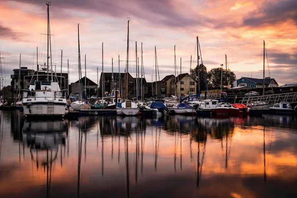 a group of boats docked in a marina at sunset at Calailan Highland Seaside Retreat - Nairn in Nairn