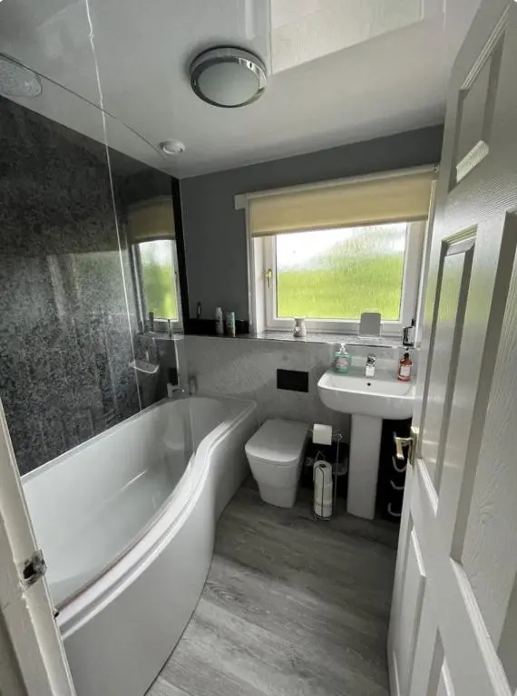 a bathroom with a tub and a toilet and a sink at Townhead Road in Inverurie