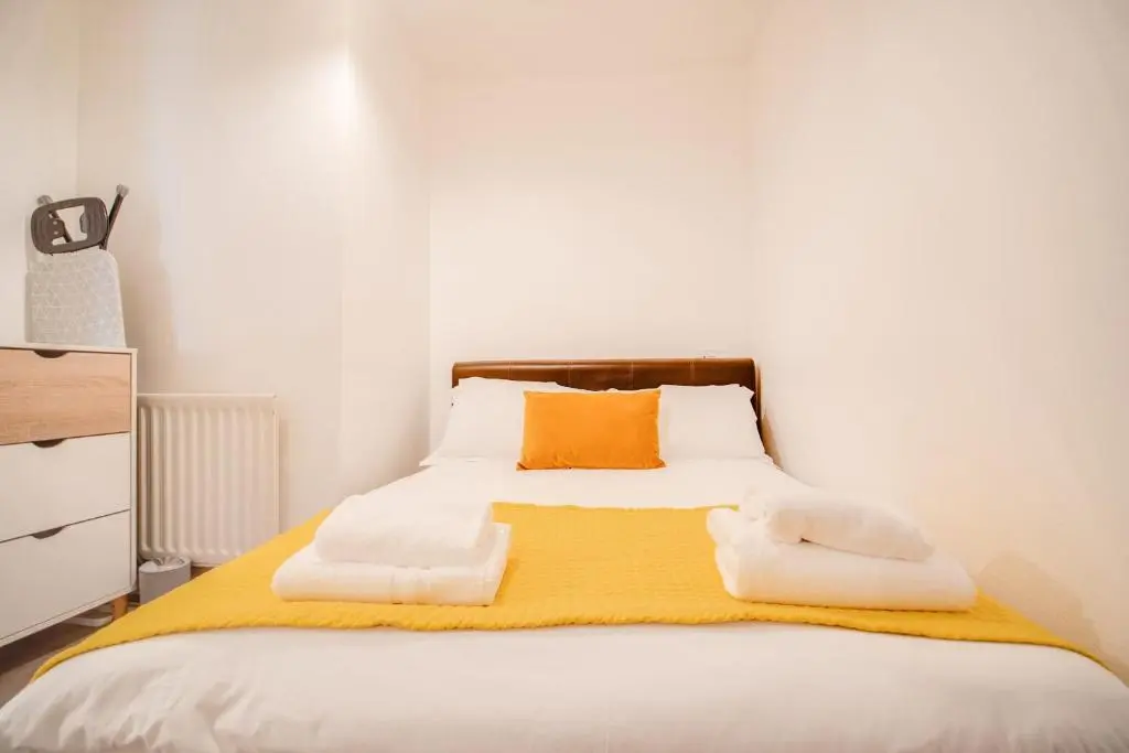a bedroom with a bed with towels on it at Comfortable 2-Bedroom Inverness Flat in Inverness