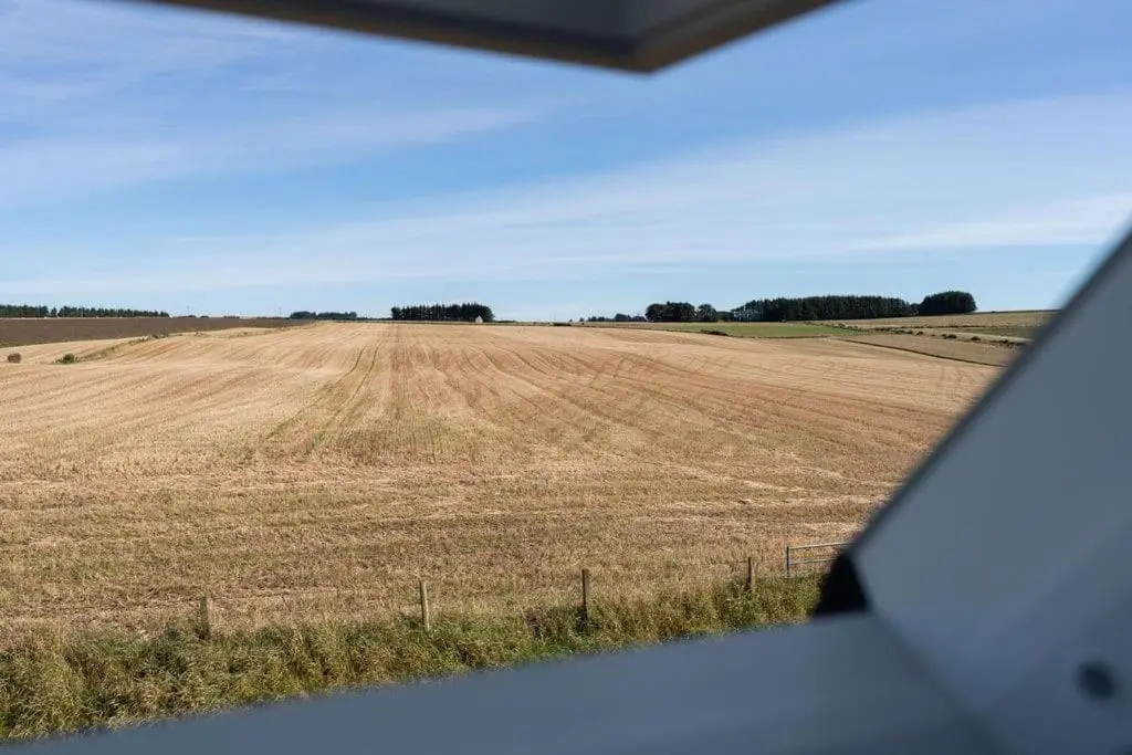 a view of a field from the window of a vehicle at Easter Cottage -4 Bed Converted Barn Cottage in Turriff