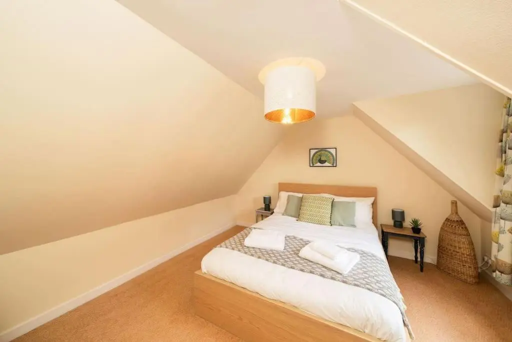 a bedroom with a bed in a attic at Red Squirrel Cottage, Family & Pet Friendly Adventure Retreat, Strathdon, Aberdeenshire in Towie