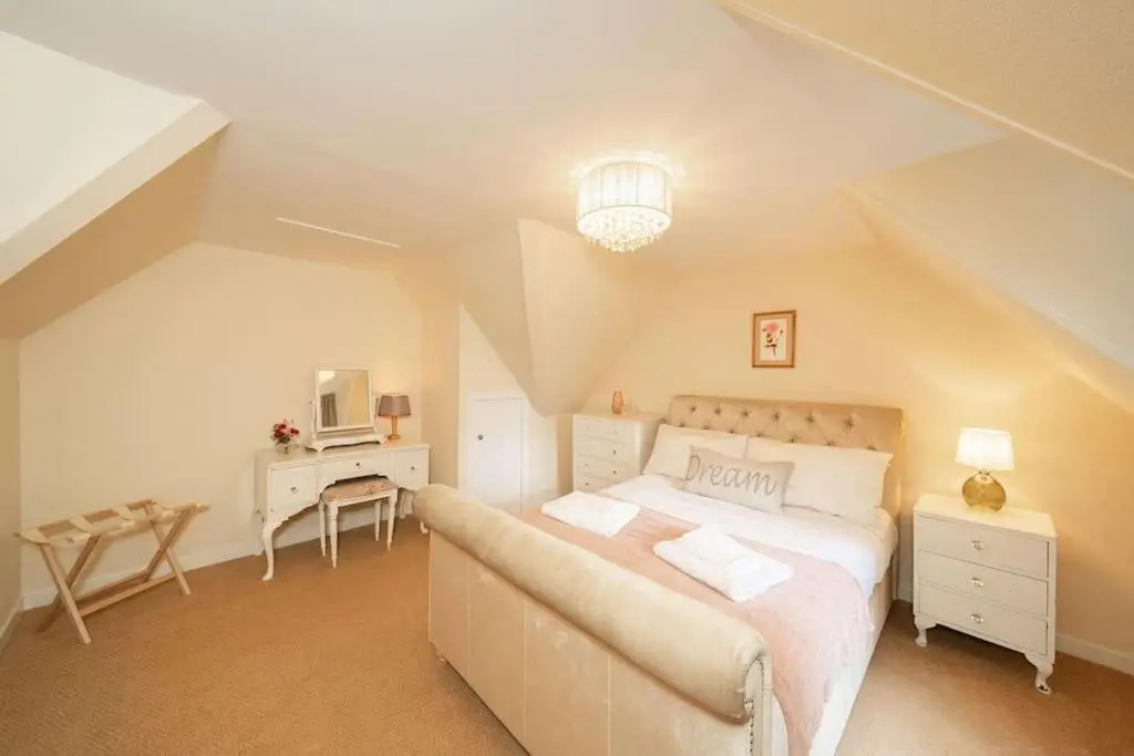 a bedroom with a bed and a desk in a attic at Red Squirrel Cottage, Family & Pet Friendly Adventure Retreat, Strathdon, Aberdeenshire in Towie