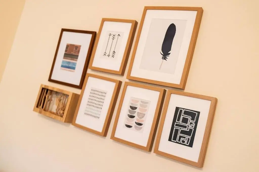 a group of framed pictures on a wall at Red Squirrel Cottage, Family & Pet Friendly Adventure Retreat, Strathdon, Aberdeenshire in Towie