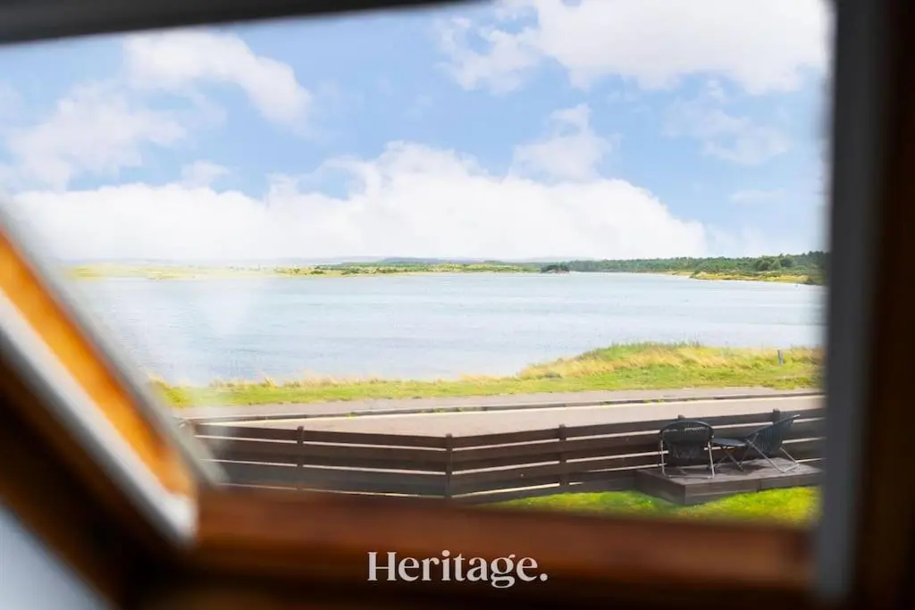 a view of a lake from a train window at Beach Cottage, Pet & Family Friendly Stay in Moray in Lossiemouth