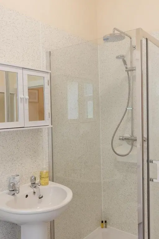 a bathroom with a sink and a shower at Dalvey Abbotshill Farm House in Forres
