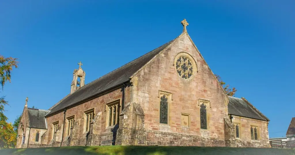 an old brick church with a cross on top of it at Stunning Country Cottage in Ardross Close To Traitors Castle & NC500 in Boath