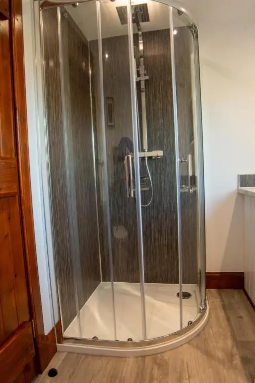 a shower with a glass enclosure in a room at Stunning Country Cottage in Ardross Close To Traitors Castle & NC500 in Boath