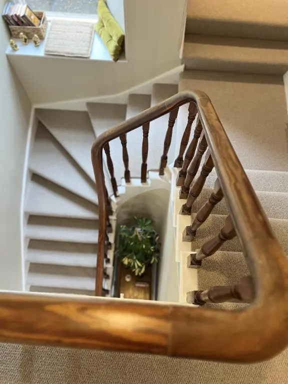 a stairwell with a wooden stair case at No. Ten Guesthouse in Tain